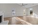 Inviting living room featuring gleaming hardwood floors, a fireplace, and large windows at 13701 Dawlish Ln, Pineville, NC 28134