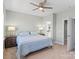 Well-lit bedroom with comfortable bed, bedside tables, and access to the en suite bathroom at 13923 Jacks Ln, Pineville, NC 28134