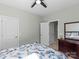 Bright bedroom with tropical themed bedding, ceiling fan, and neutral wall color providing a calming atmosphere at 13923 Jacks Ln, Pineville, NC 28134