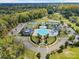 Beautiful aerial of the community pool, tennis courts, clubhouse and playground surrounded by trees at 13923 Jacks Ln, Pineville, NC 28134