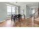 Open dining area featuring modern lighting, hardwood floors, and a view of the staircase at 13923 Jacks Ln, Pineville, NC 28134