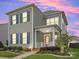 Charming two-story home boasts a red front door, inviting curb appeal and gray siding at 13923 Jacks Ln, Pineville, NC 28134