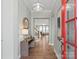 Welcoming foyer features hardwood floors, a console table with lamp, and a red-framed glass door at 13923 Jacks Ln, Pineville, NC 28134