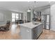 Kitchen island featuring a sink with a view into the living and dining areas at 13923 Jacks Ln, Pineville, NC 28134