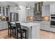 Island with granite countertops and gray cabinets offering a stylish cooking space at 13923 Jacks Ln, Pineville, NC 28134