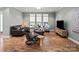 Inviting living room with hardwood floors, modern furniture, and a neutral color scheme at 13923 Jacks Ln, Pineville, NC 28134