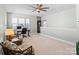 Bright living room featuring multiple windows, ceiling fan, and comfortable seating at 13923 Jacks Ln, Pineville, NC 28134