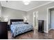 A serene main bedroom featuring neutral colors, hardwood floors, and ample natural light at 13923 Jacks Ln, Pineville, NC 28134