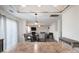 Bright dining area with a view of the living room and a decorative chandelier at 203 Waterlemon Way, Monroe, NC 28110