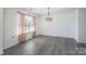Spacious and empty room featuring wood floors and natural lighting at 203 Waterlemon Way, Monroe, NC 28110
