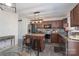 Cozy kitchen with stainless steel appliances, dark wood cabinets, and an island with bar stools at 203 Waterlemon Way, Monroe, NC 28110