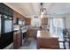 Well-equipped kitchen with stainless steel appliances, dark wood cabinets, and a breakfast bar at 203 Waterlemon Way, Monroe, NC 28110