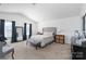 Spacious main bedroom with a high ceiling, plush carpeting, and ample natural light at 203 Waterlemon Way, Monroe, NC 28110