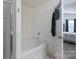 Clean bathtub inside the bathroom with an open door to the bedroom at 203 Waterlemon Way, Monroe, NC 28110