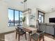 Bright dining room features large windows with city views and modern furnishings at 222 S Caldwell St # 1803, Charlotte, NC 28202