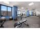 Well-equipped gym with modern exercise machines and natural light, promoting a healthy lifestyle at 222 S Caldwell St # 1803, Charlotte, NC 28202