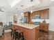 Kitchen island with granite counters offers seating in this modern-style kitchen with stainless appliances at 222 S Caldwell St # 1803, Charlotte, NC 28202