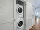 Convenient laundry closet with stacked washer and dryer, maximizing space in a modern home at 222 S Caldwell St # 1803, Charlotte, NC 28202