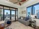 Bright living space with expansive windows, a city view, and access to a balcony at 222 S Caldwell St # 1803, Charlotte, NC 28202