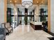 Elegant lobby with marble floors, chandelier, and mirrored walls, creating a grand entrance at 222 S Caldwell St # 1803, Charlotte, NC 28202