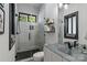 Modern bathroom featuring tiled walls, glass shower, floating vanity, and contemporary fixtures at 231 Sunny Path Ln, Statesville, NC 28677