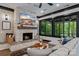 Inviting living room with a stone fireplace, tv, hardwood floors, and comfortable furnishings at 231 Sunny Path Ln, Statesville, NC 28677