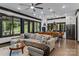 Open-concept living room with large sectional sofa, hardwood floors, and natural light at 231 Sunny Path Ln, Statesville, NC 28677