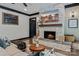 Inviting living room with a stone fireplace, tv, hardwood floors, and comfortable furnishings at 231 Sunny Path Ln, Statesville, NC 28677