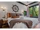 Bright primary bedroom featuring a decorative ship wheel, modern lighting, and natural light at 231 Sunny Path Ln, Statesville, NC 28677
