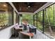 Spacious covered porch offers outdoor seating, a fireplace, and peaceful views of the wooded surroundings at 231 Sunny Path Ln, Statesville, NC 28677