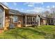 View of the brick house exterior, showcasing a screened-in porch and grassy backyard at 234 Pointe Cir, Rock Hill, SC 29732