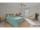 Cozy bedroom features a ceiling fan, a bright window, and a comfortable seating area at 234 Pointe Cir, Rock Hill, SC 29732