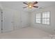 Bright bedroom features neutral walls, two closets and a window with blinds, with a ceiling fan at 234 Pointe Cir, Rock Hill, SC 29732