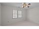 Bright bedroom with neutral walls, large window with blinds, and a ceiling fan with light fixture at 234 Pointe Cir, Rock Hill, SC 29732