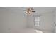 A bright bedroom features neutral walls, a window with blinds, and ceiling fan at 234 Pointe Cir, Rock Hill, SC 29732