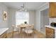 Dining room with a round wooden table, four chairs, and decorative wallpaper at 234 Pointe Cir, Rock Hill, SC 29732