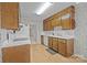 Well-lit kitchen featuring wood cabinets, white appliances, and linoleum floors at 234 Pointe Cir, Rock Hill, SC 29732