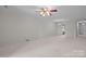 Spacious living room with carpeted floors, ceiling fan, and view to another room at 234 Pointe Cir, Rock Hill, SC 29732
