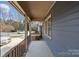 Inviting, covered front porch featuring classic railings and views of the landscaped front yard at 234 Pointe Cir, Rock Hill, SC 29732