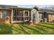 The back of the house features a screened porch with steps down to the grassy lawn at 234 Pointe Cir, Rock Hill, SC 29732
