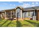 A back exterior view of the house shows a screened porch with access steps to the lawn at 234 Pointe Cir, Rock Hill, SC 29732