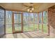 Cozy screened porch with wood floors, screens, fan, and views of nature at 234 Pointe Cir, Rock Hill, SC 29732