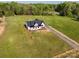 Aerial view of new construction home and long driveway surrounded by lush green land and mature trees at 2355 Emanuel Church Rd, Rockwell, NC 28138