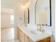 Bathroom showcasing double vanity with gold fixtures and framed mirrors in neutral color palette at 2355 Emanuel Church Rd, Rockwell, NC 28138