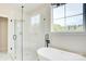 Bright bathroom with a glass shower, freestanding tub, and a large window for natural light at 2355 Emanuel Church Rd, Rockwell, NC 28138