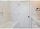 Bright, tiled bathroom with shower and tub with quartz countertop vanity and bronze hardware at 2355 Emanuel Church Rd, Rockwell, NC 28138