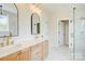Bright bathroom featuring double vanity, a glass shower with marble-look tile, and modern lighting at 2355 Emanuel Church Rd, Rockwell, NC 28138