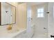 Bathroom featuring white cabinets, dual sinks, quartz countertops, gold hardware and framed mirror at 2355 Emanuel Church Rd, Rockwell, NC 28138