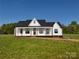 Charming new construction home with a welcoming front porch and modern farmhouse design at 2355 Emanuel Church Rd, Rockwell, NC 28138