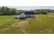 Exterior of home showing the yard space with a lush green backdrop and unfinished construction at 2355 Emanuel Church Rd, Rockwell, NC 28138